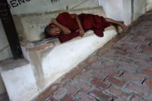 Monk resting on thes stairs to Soon U Pon Nya Shin Paya